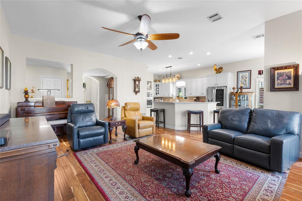 1007 Santa Fe Street Denton, TX 76205 - Photo 9 of 37 Living area with arched walkways, ceiling fan, recessed lighting, and light wood finished floors
