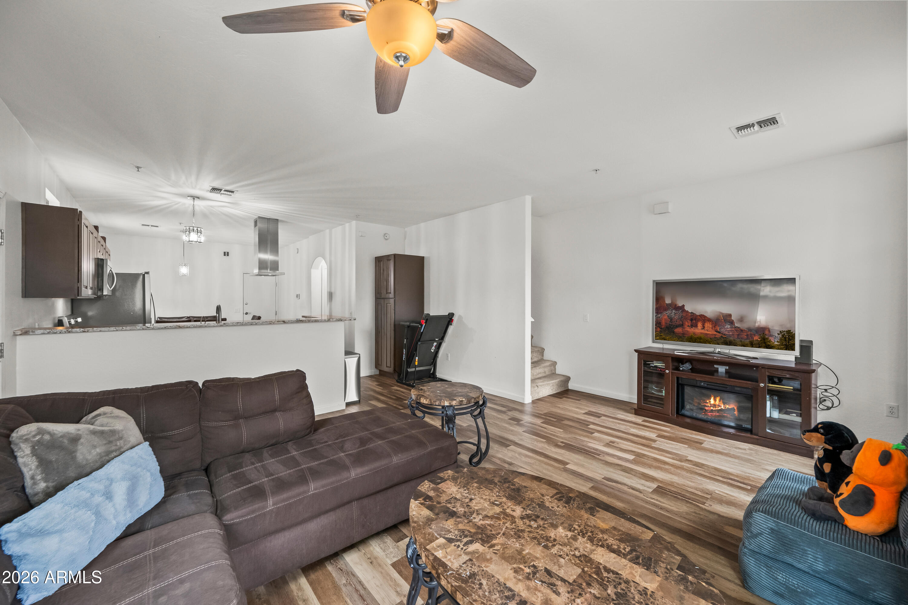 2150 East Bell Road, Unit 1159 Phoenix, AZ 85022 - Photo 11 of 26 a living room with furniture and a flat screen tv