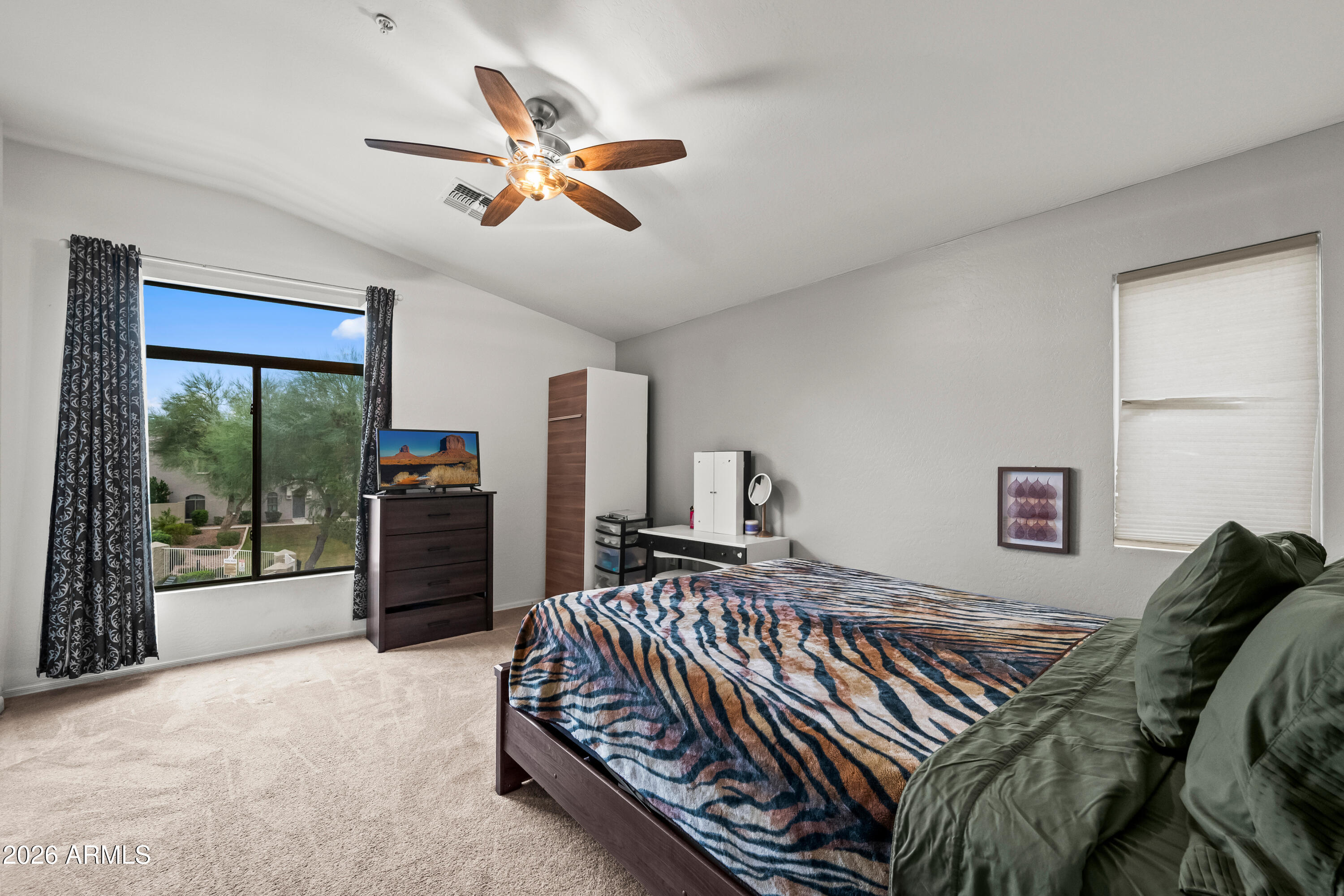2150 East Bell Road, Unit 1159 Phoenix, AZ 85022 - Photo 14 of 26 a bedroom with a bed and glass window