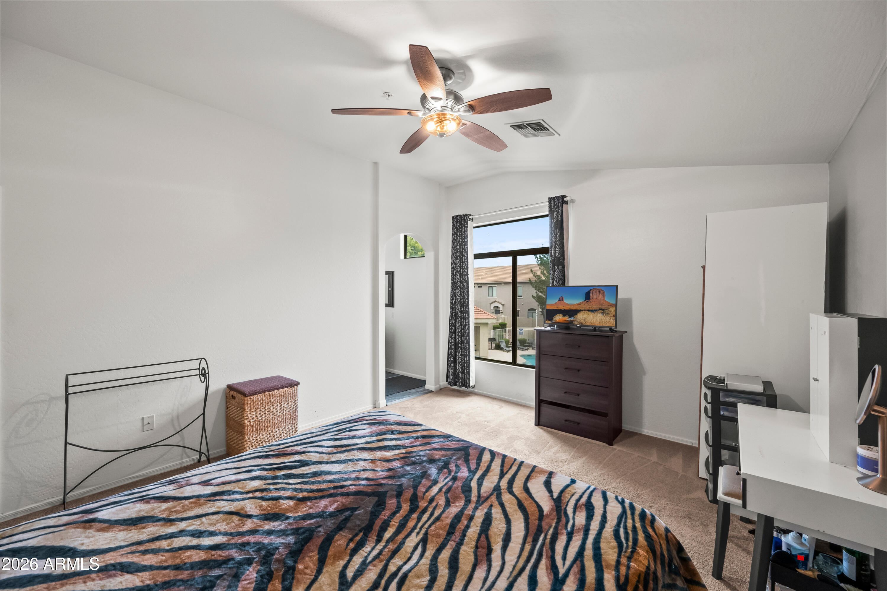 2150 East Bell Road, Unit 1159 Phoenix, AZ 85022 - Photo 15 of 26 a bedroom with a bed and a chandelier