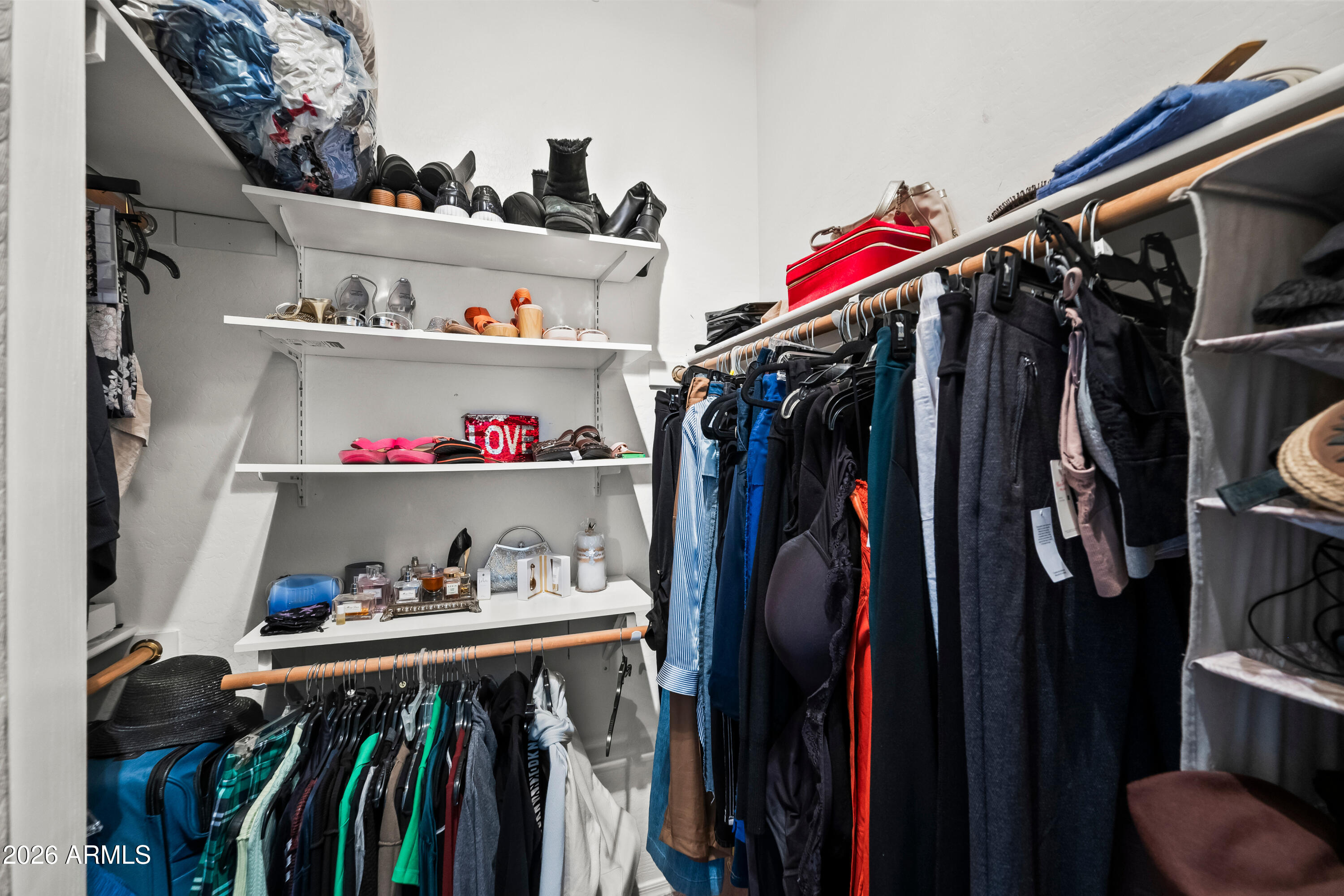 2150 East Bell Road, Unit 1159 Phoenix, AZ 85022 - Photo 16 of 26 a view of walk in closet with clothes and shoes