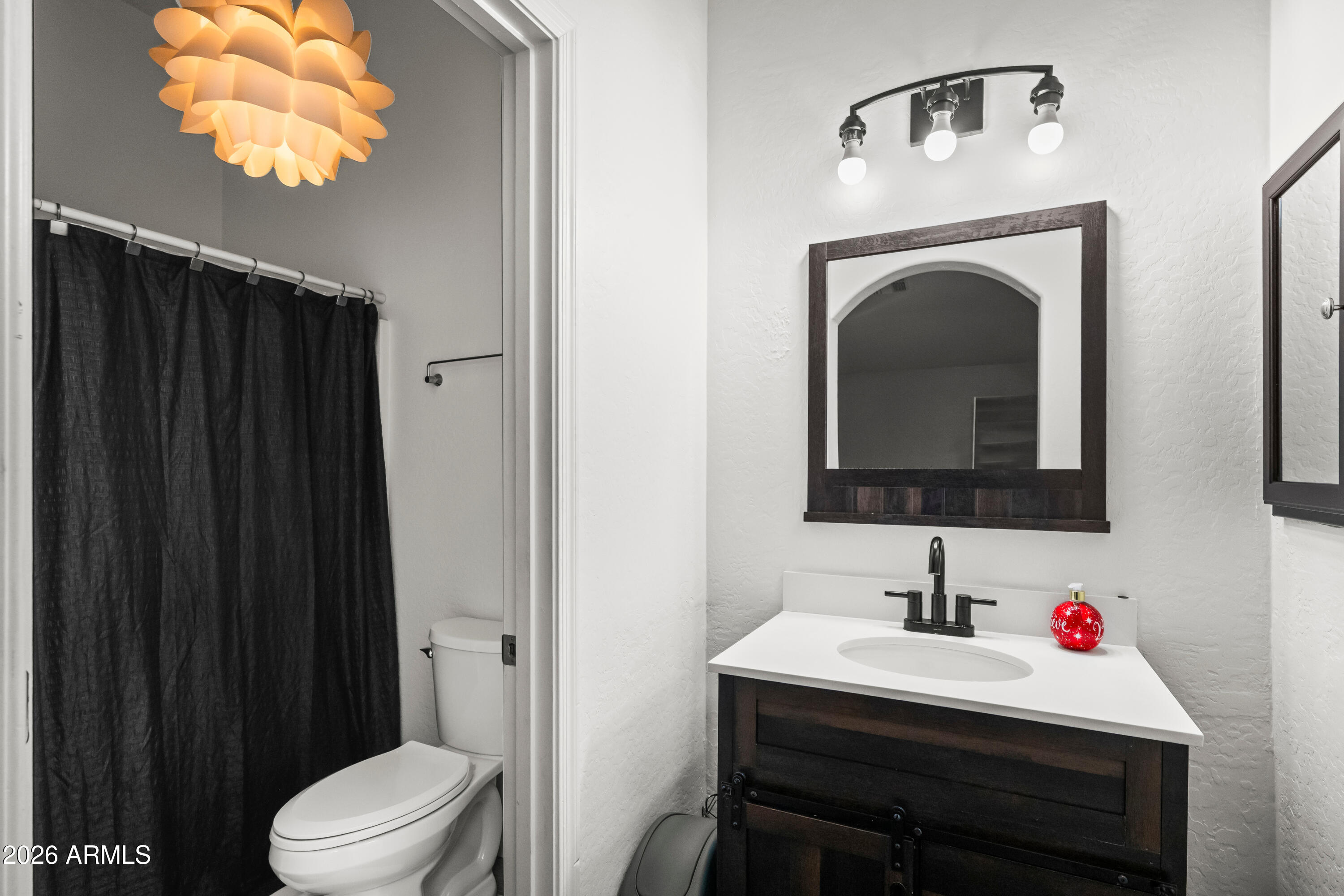 2150 East Bell Road, Unit 1159 Phoenix, AZ 85022 - Photo 17 of 26 a bathroom with a sink vanity and mirror