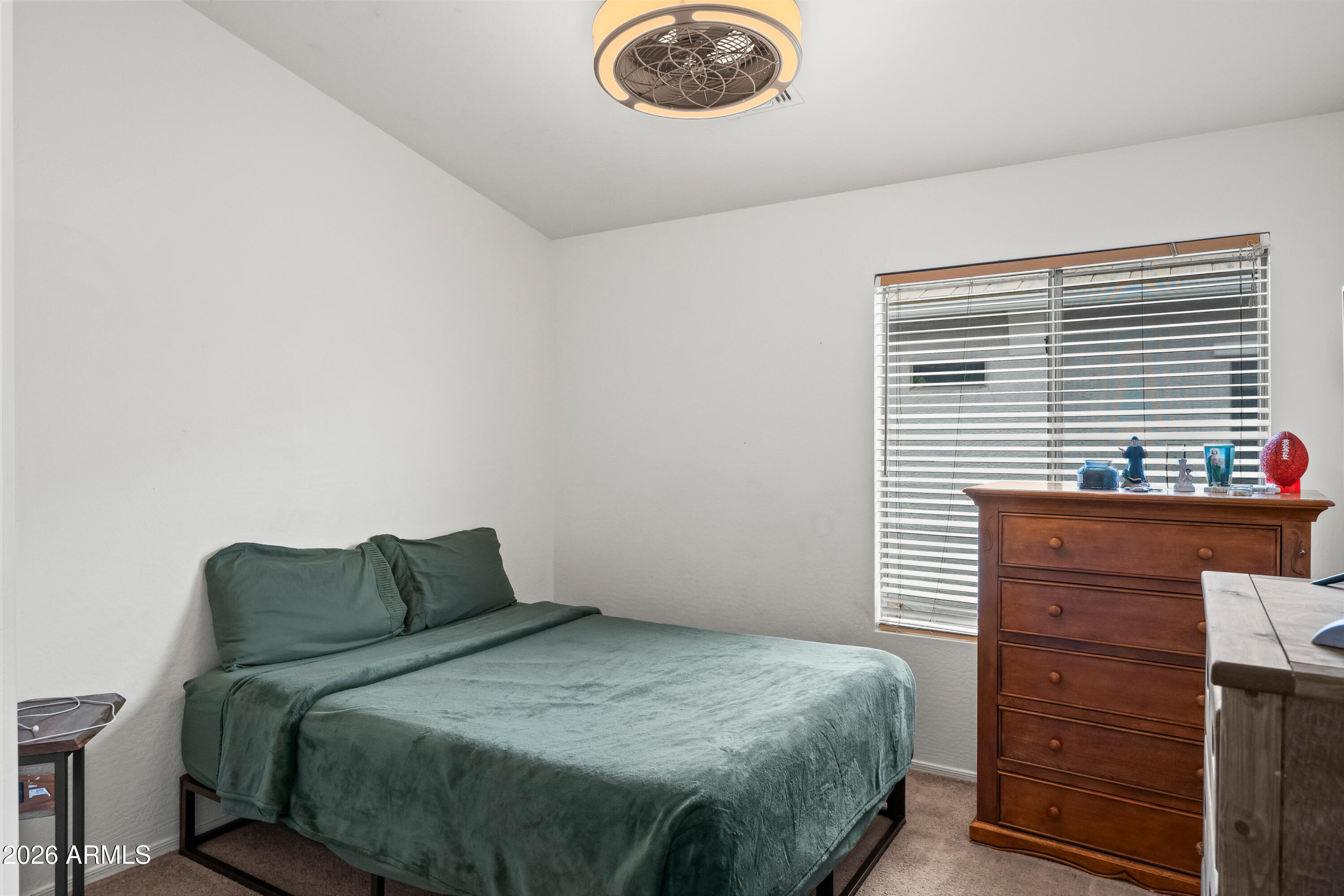 2150 East Bell Road, Unit 1159 Phoenix, AZ 85022 - Photo 18 of 26 a bedroom with a bed and a window