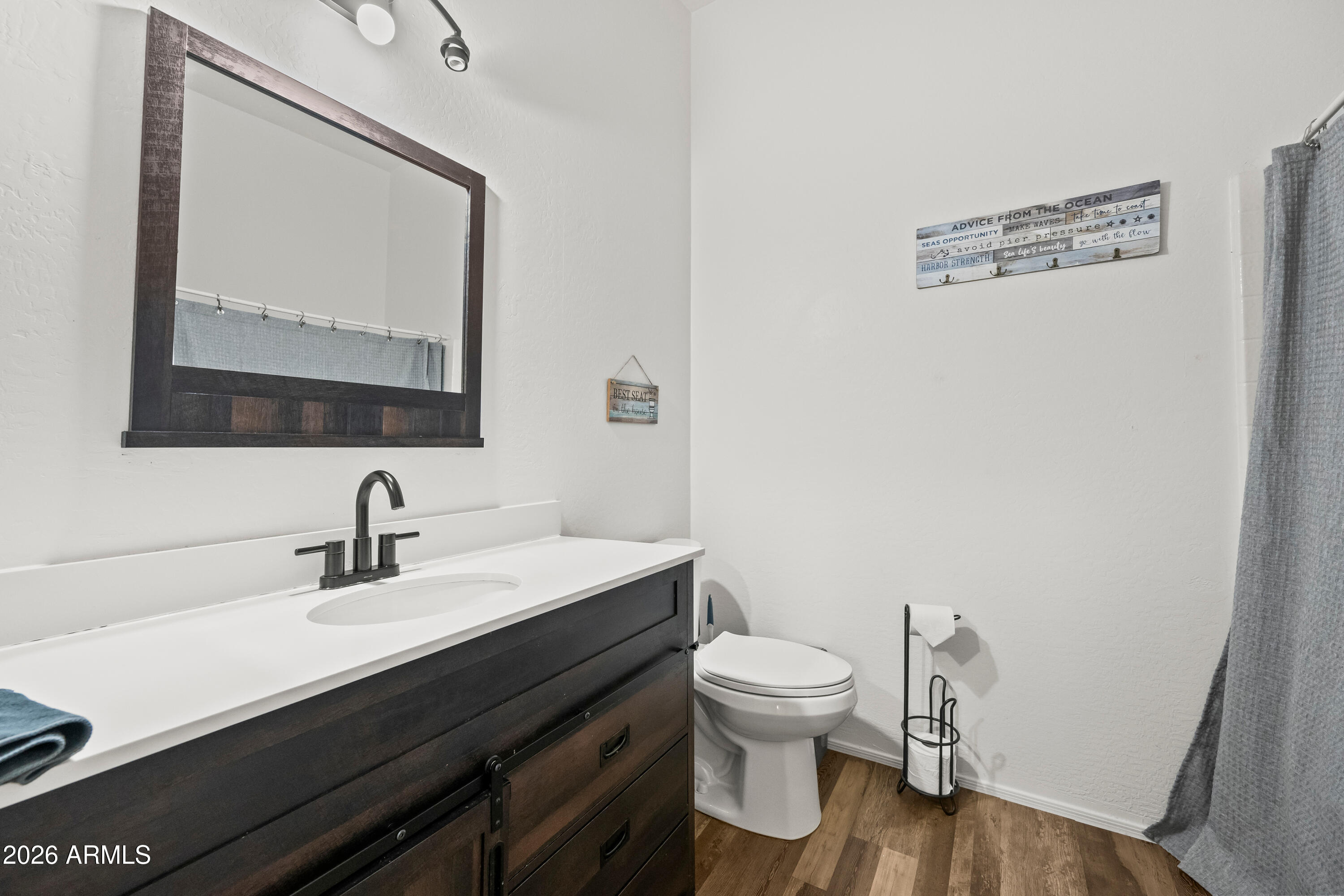 2150 East Bell Road, Unit 1159 Phoenix, AZ 85022 - Photo 21 of 26 a bathroom with a toilet sink and mirror