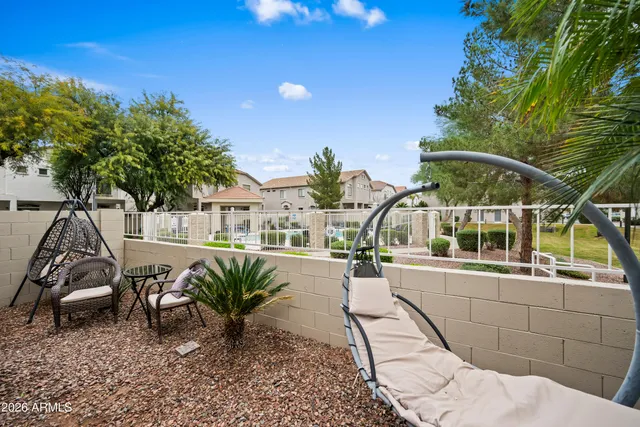 a view of a house with backyard and sitting area