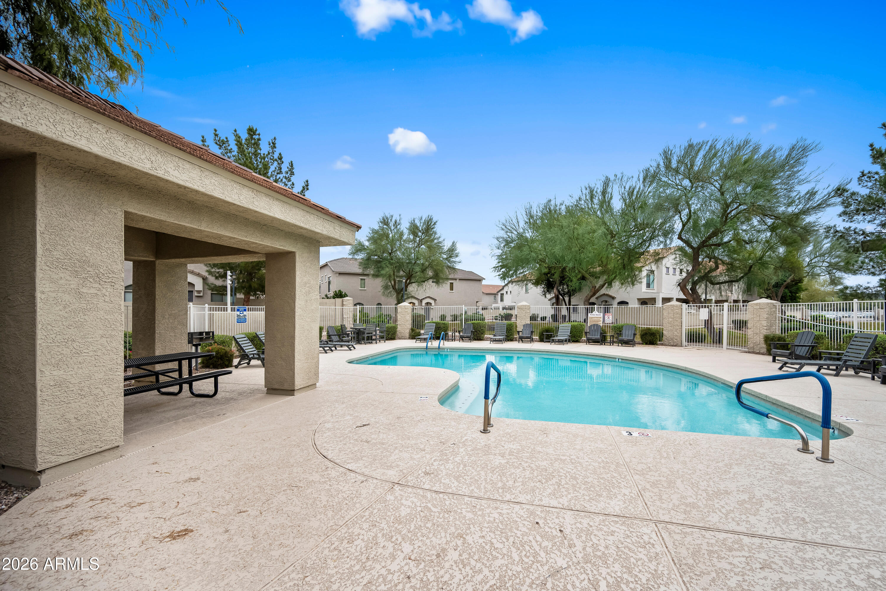 2150 East Bell Road, Unit 1159 Phoenix, AZ 85022 - Photo 6 of 26 a view of a swimming pool with chairs