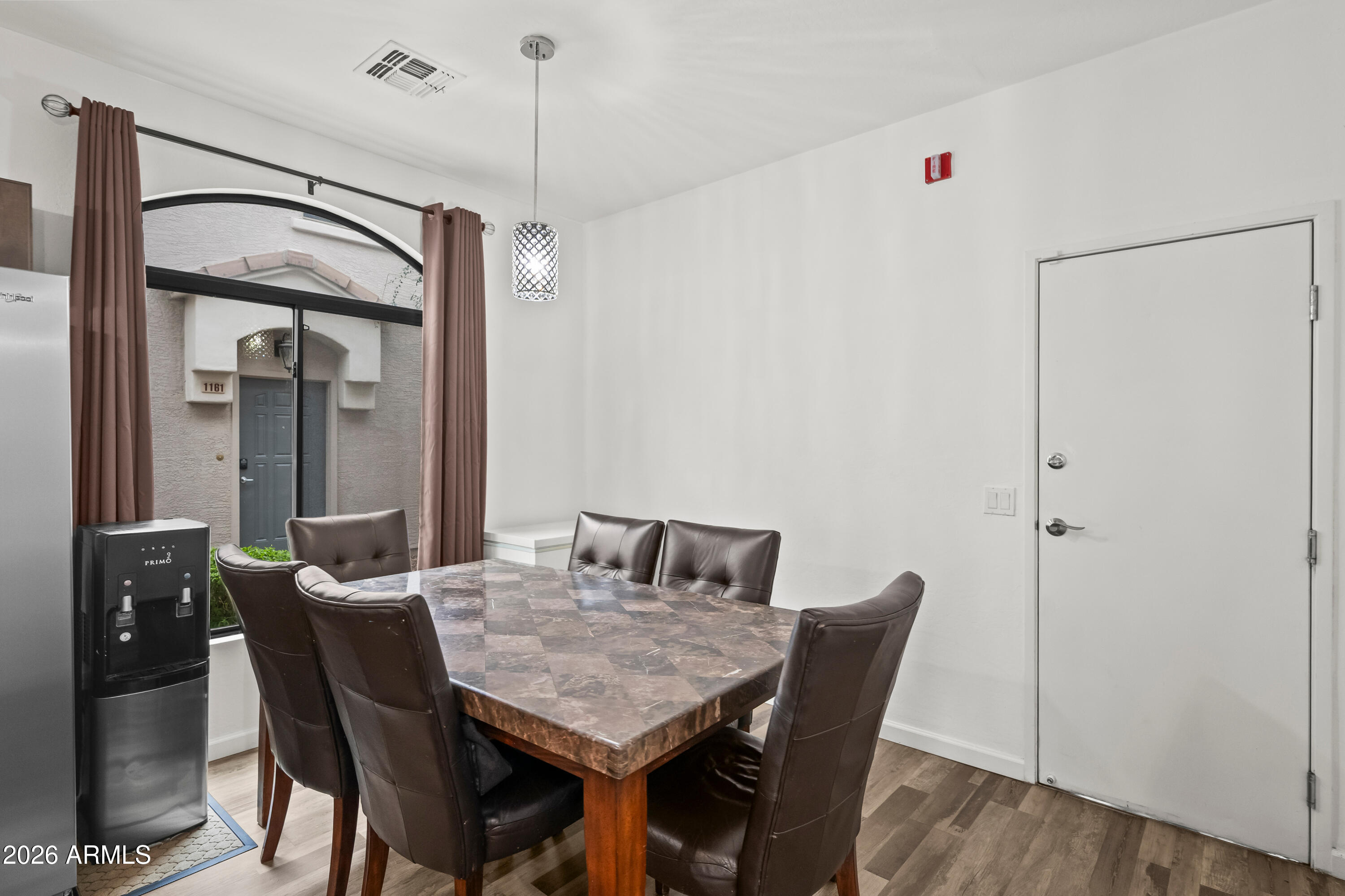 2150 East Bell Road, Unit 1159 Phoenix, AZ 85022 - Photo 8 of 26 a view of a dining room with furniture and wooden floor