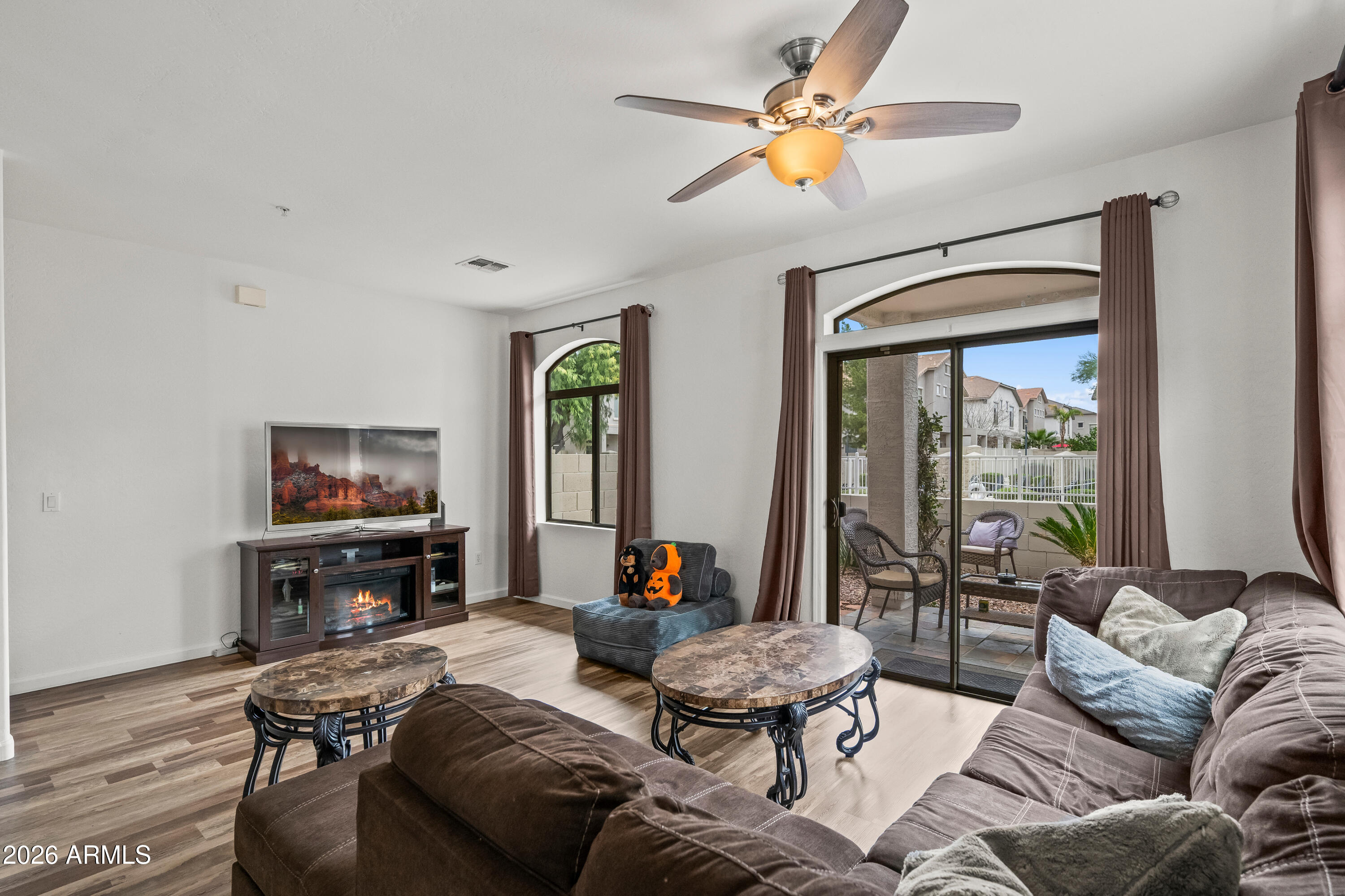 2150 East Bell Road, Unit 1159 Phoenix, AZ 85022 - Photo 10 of 26 a living room with furniture and a flat screen tv