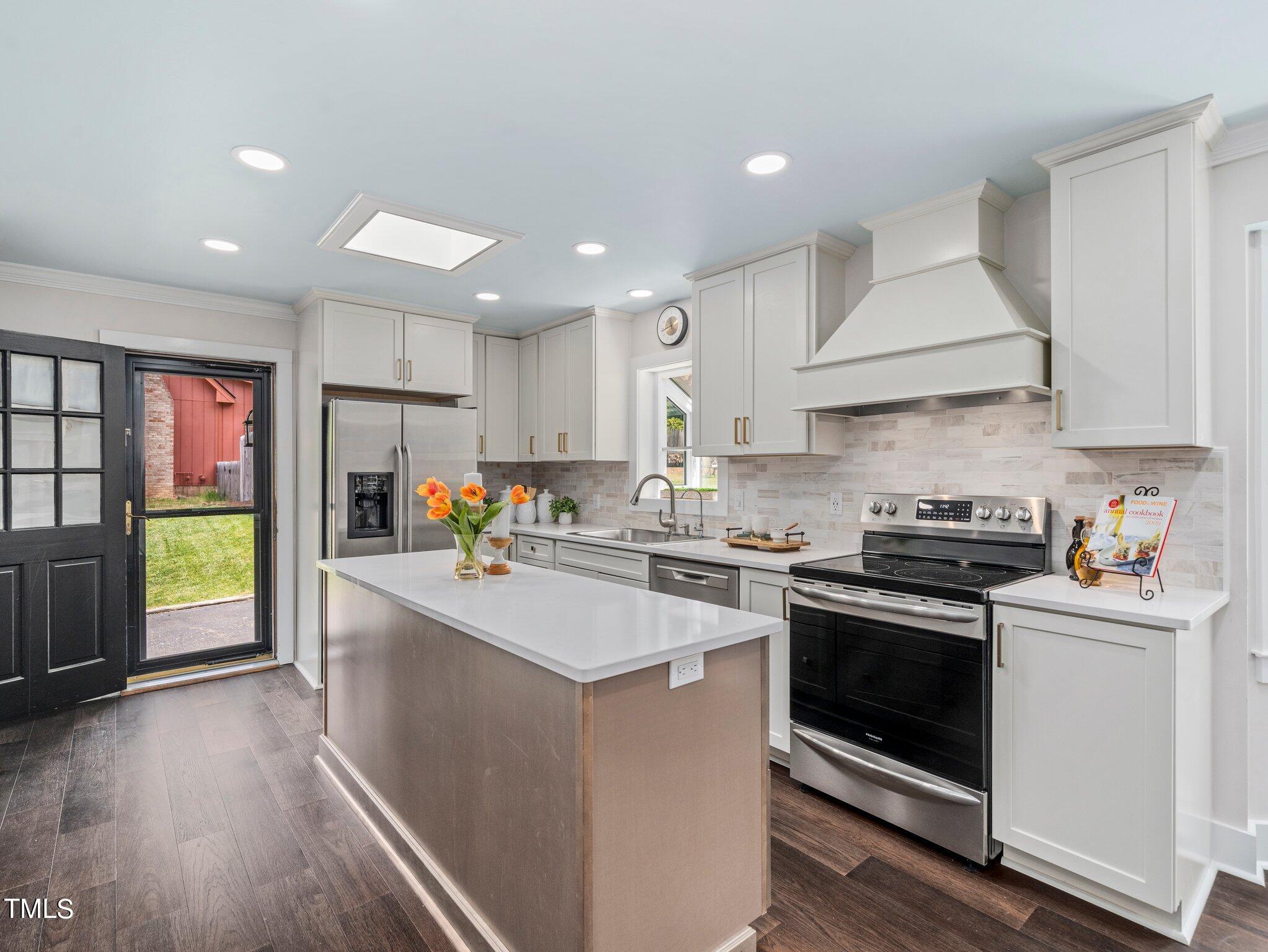 7800 Whitley Drive Raleigh, NC 27613 - Photo 3 of 17 a kitchen that has a sink and a stove