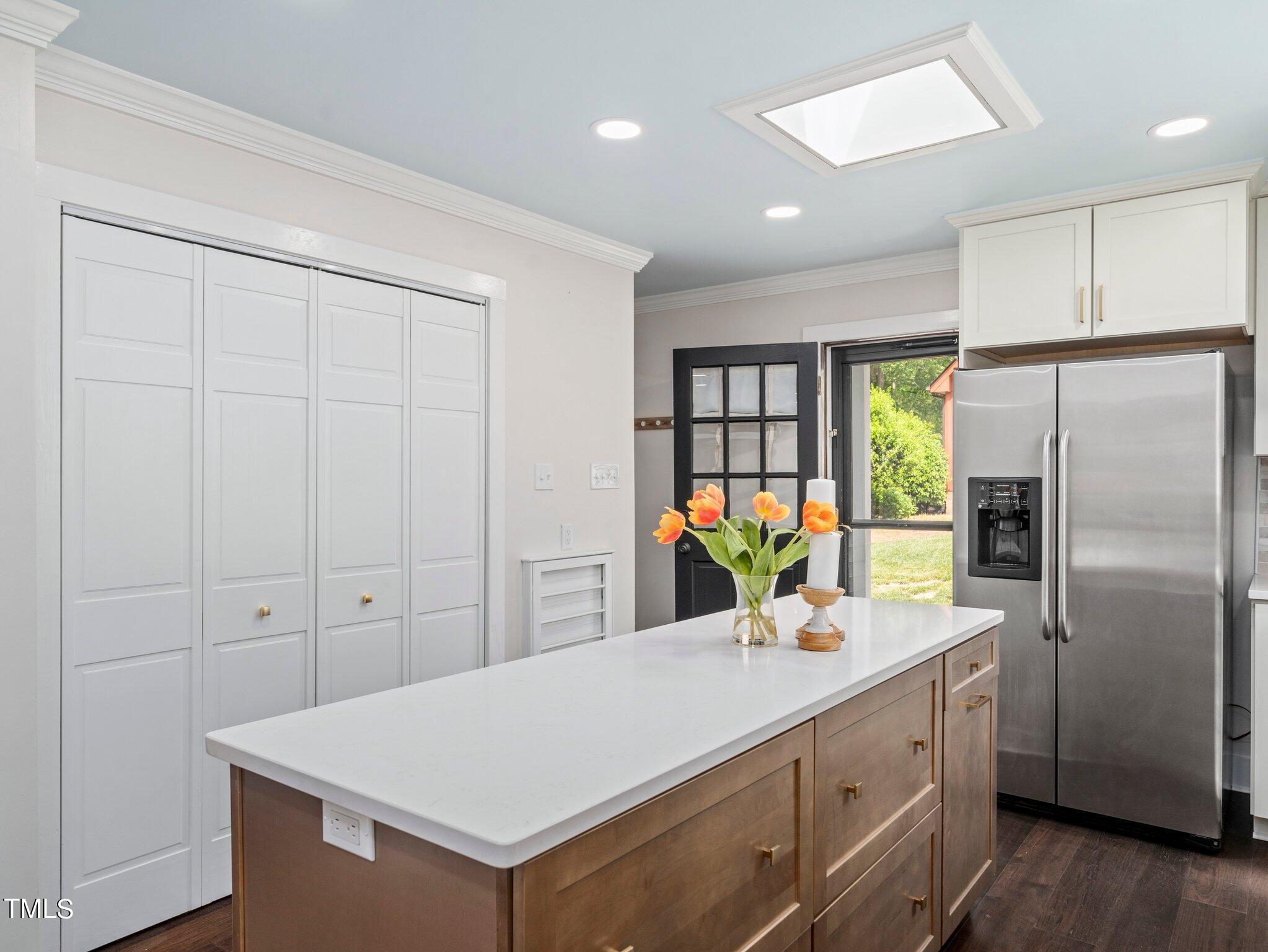 7800 Whitley Drive Raleigh, NC 27613 - Photo 5 of 17 a kitchen with kitchen island a counter space a sink appliances and cabinets