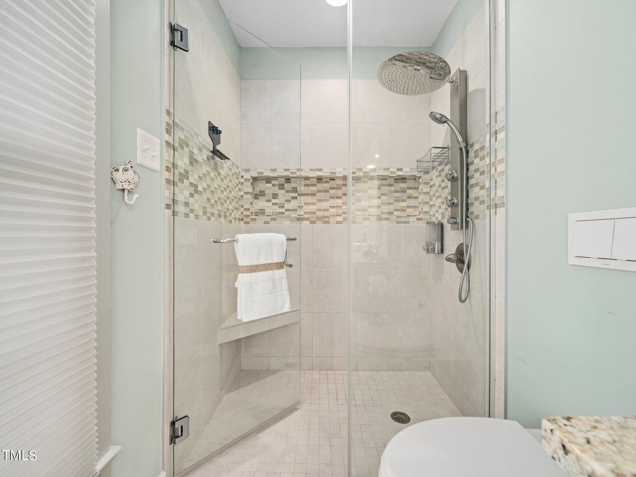 7800 Whitley Drive Raleigh, NC 27613 - Photo 10 of 17 a bathroom with a granite countertop shower a toilet and a sink