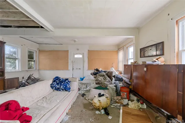 a room with furniture a flat screen tv and a window