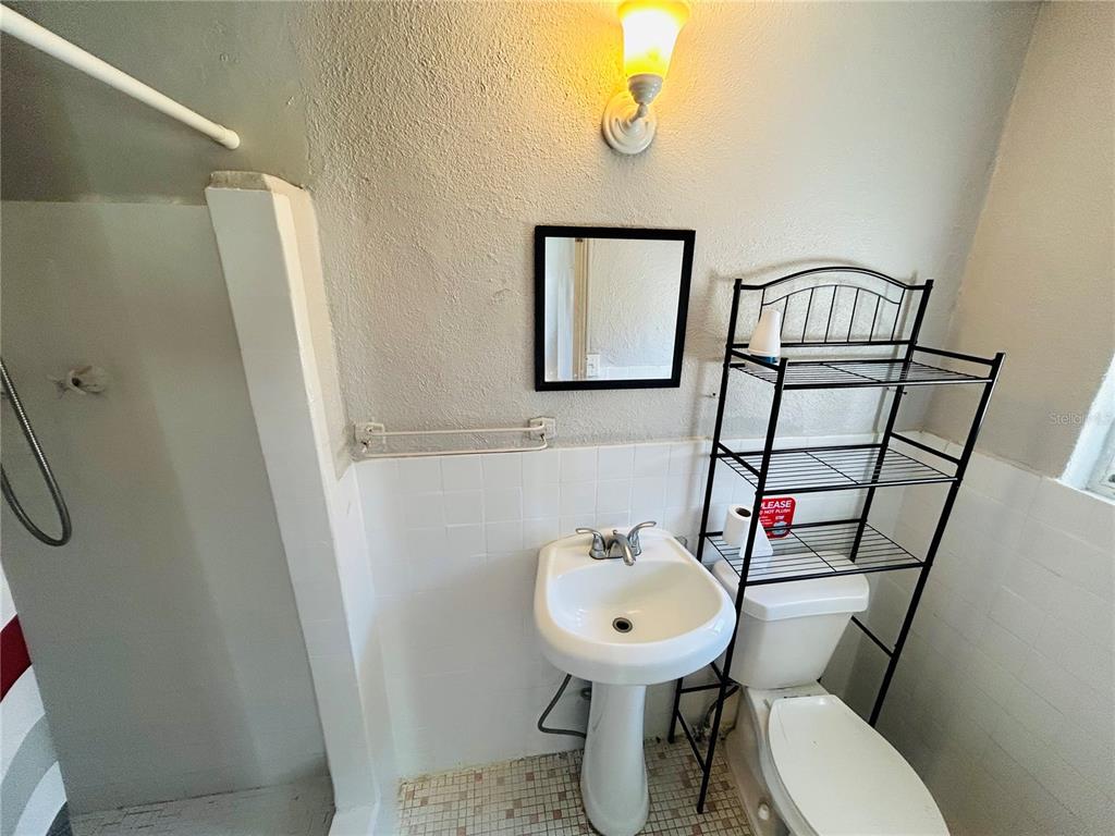 553597 Highway 1, Unit 2 Hilliard, FL 32046 - Photo 5 of 5 a bathroom with a sink toilet and mirror