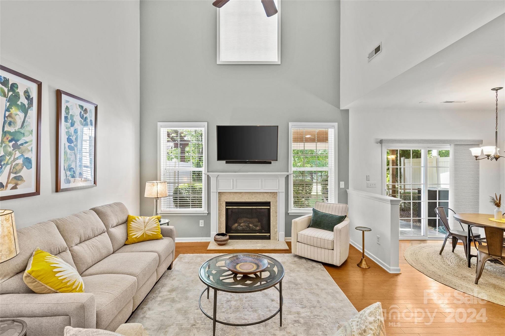 1034 Silver Gull Drive Tega Cay, SC 29708 - Photo 12 of 32 a living room with furniture a fireplace and a large window