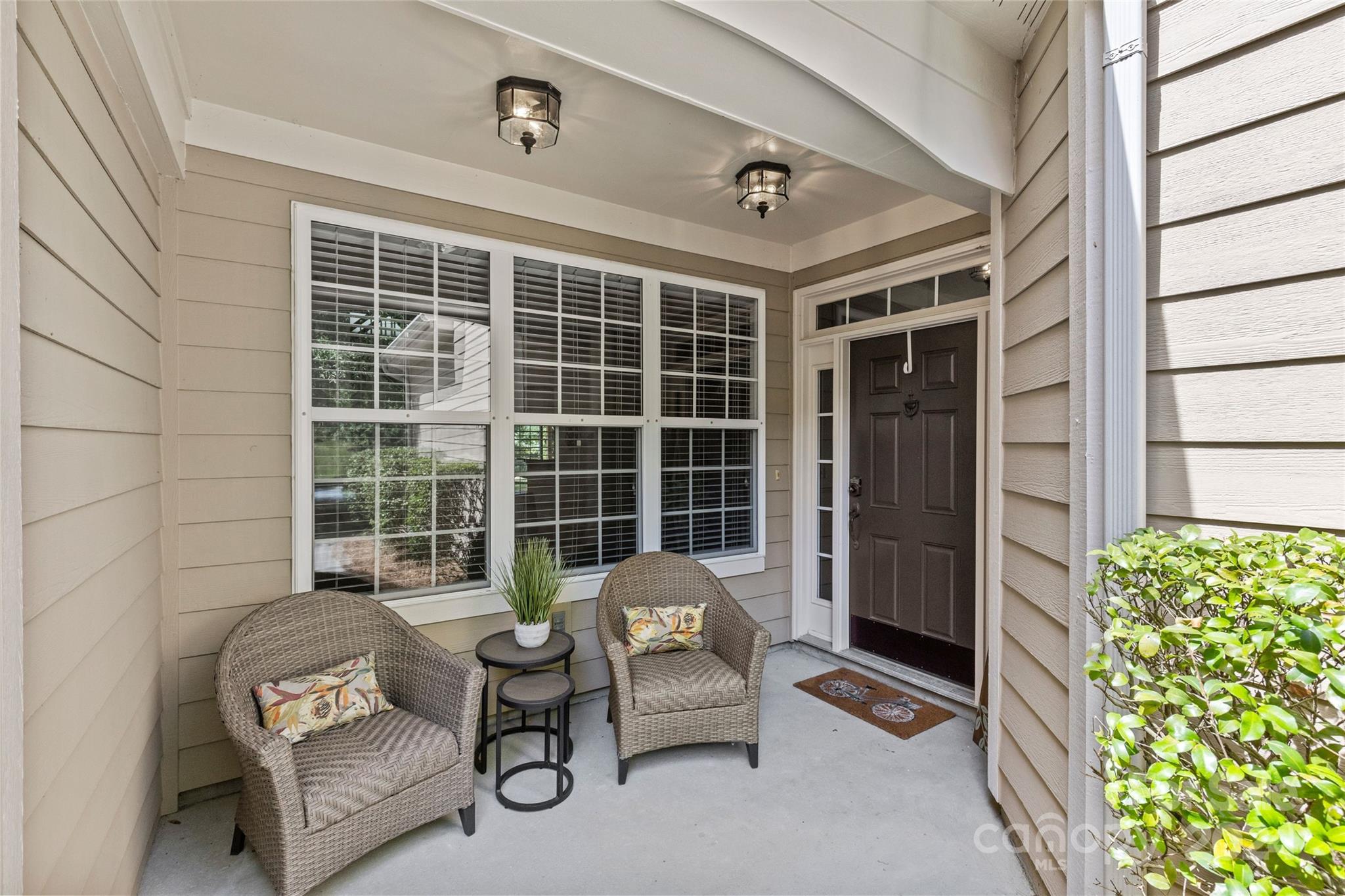 1034 Silver Gull Drive Tega Cay, SC 29708 - Photo 3 of 32 a balcony view with a couch and a potted plant