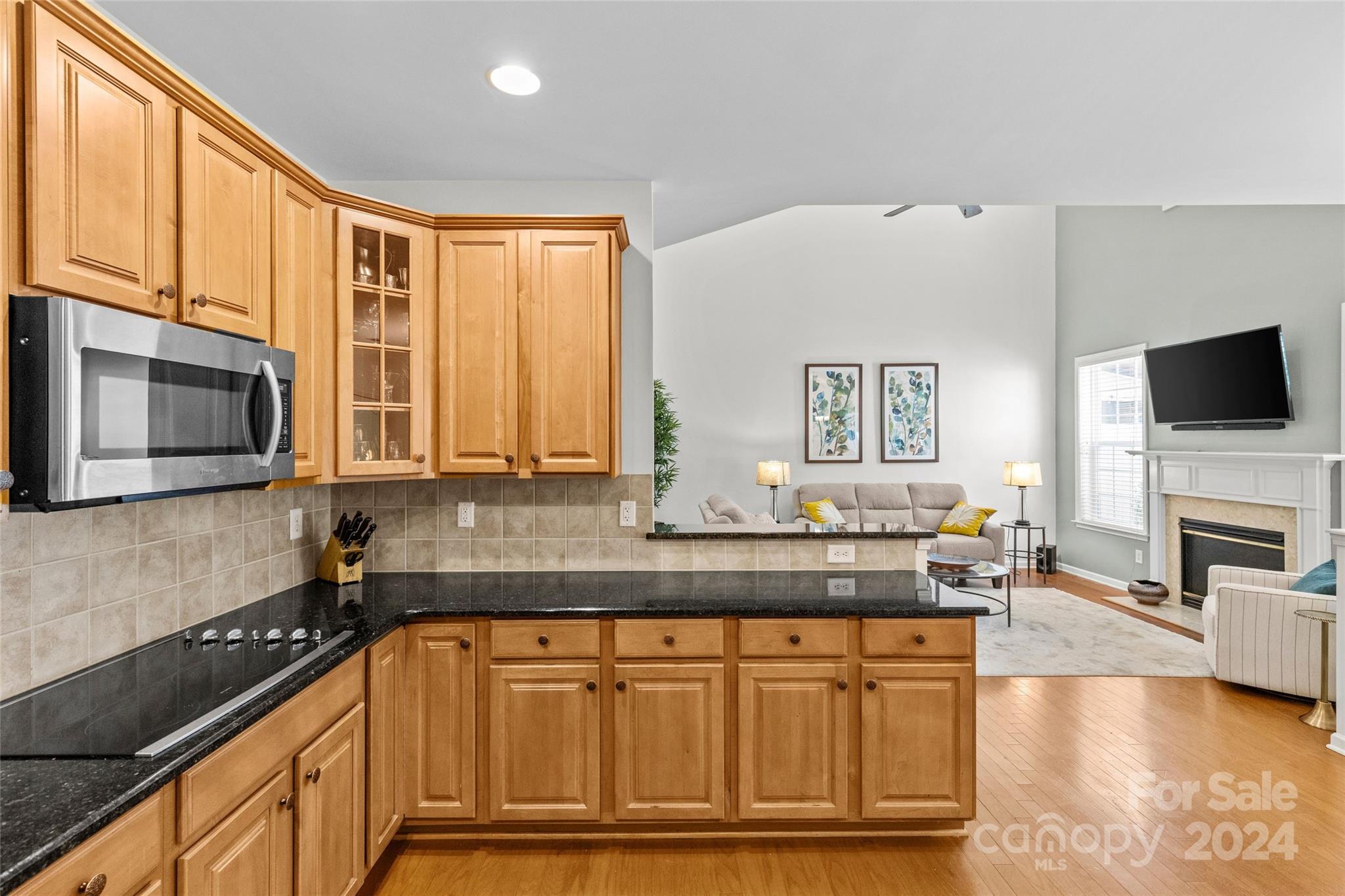 1034 Silver Gull Drive Tega Cay, SC 29708 - Photo 6 of 32 a kitchen with stainless steel appliances granite countertop a stove a sink and a microwave
