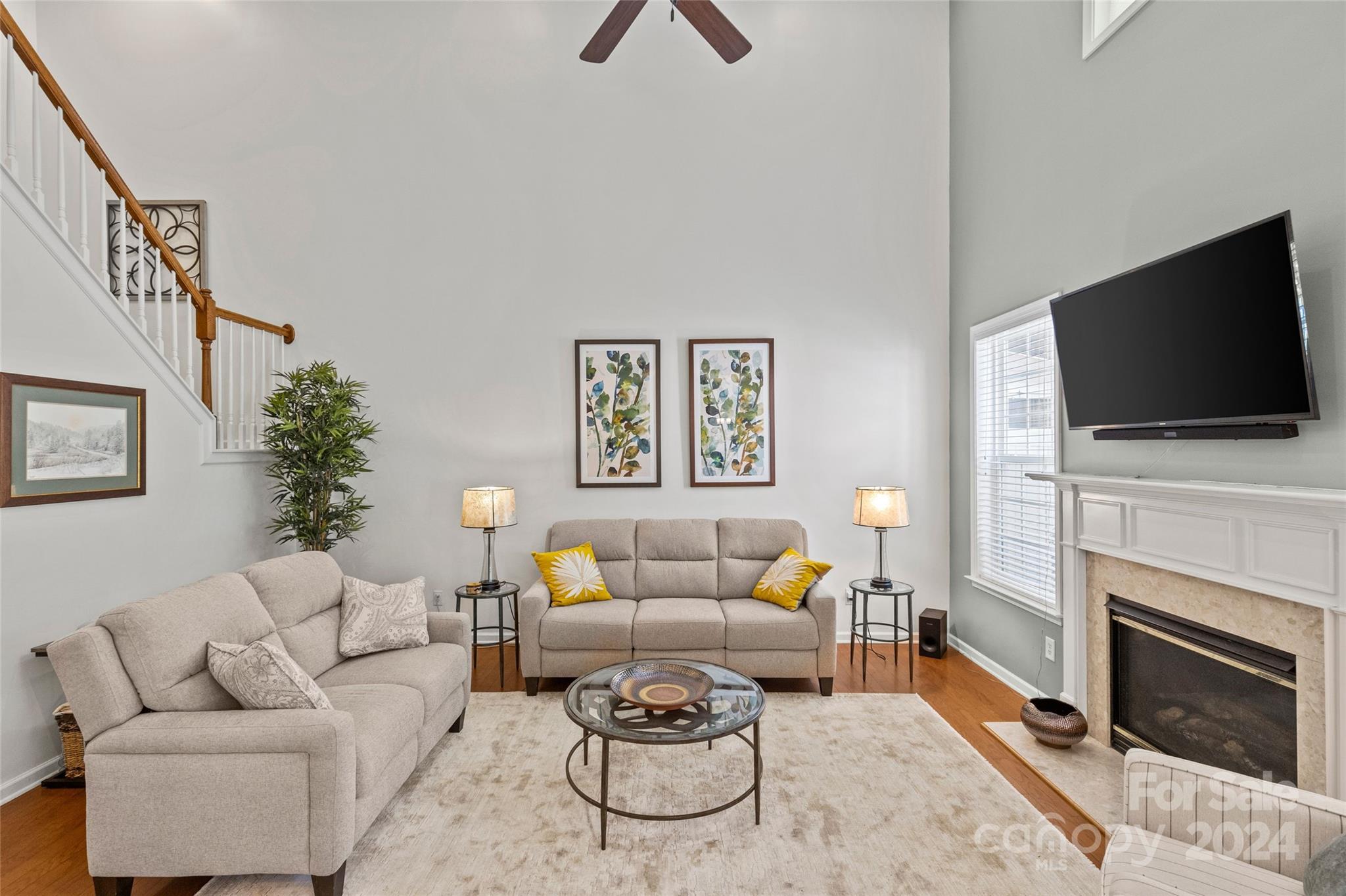 1034 Silver Gull Drive Tega Cay, SC 29708 - Photo 10 of 32 a living room with furniture a flat screen tv and a fireplace