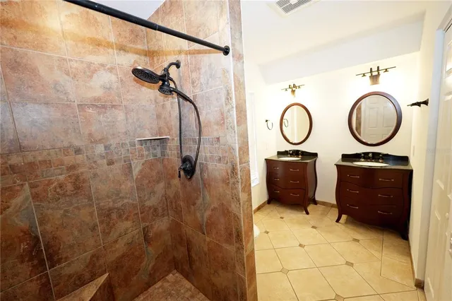 a bathroom with a sink a toilet and a shower