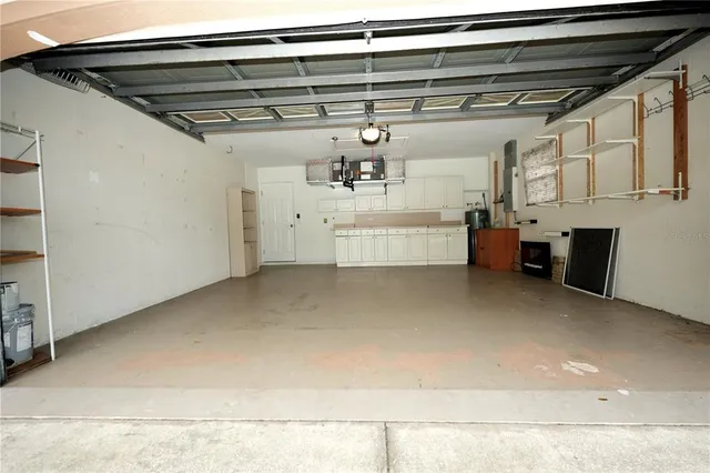 a view of a house with a small yard and large trees
