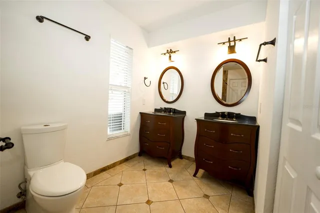 a bathroom with a toilet a sink and a mirror