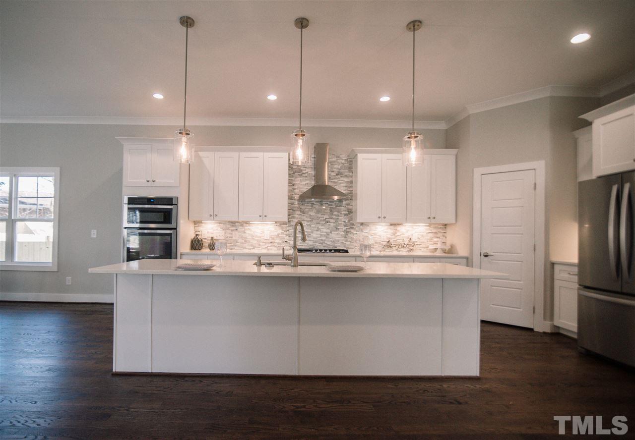 1508 East Lane Street Raleigh, NC 27610 - Photo 12 of 30 a kitchen with stainless steel appliances granite countertop a sink refrigerator and microwave