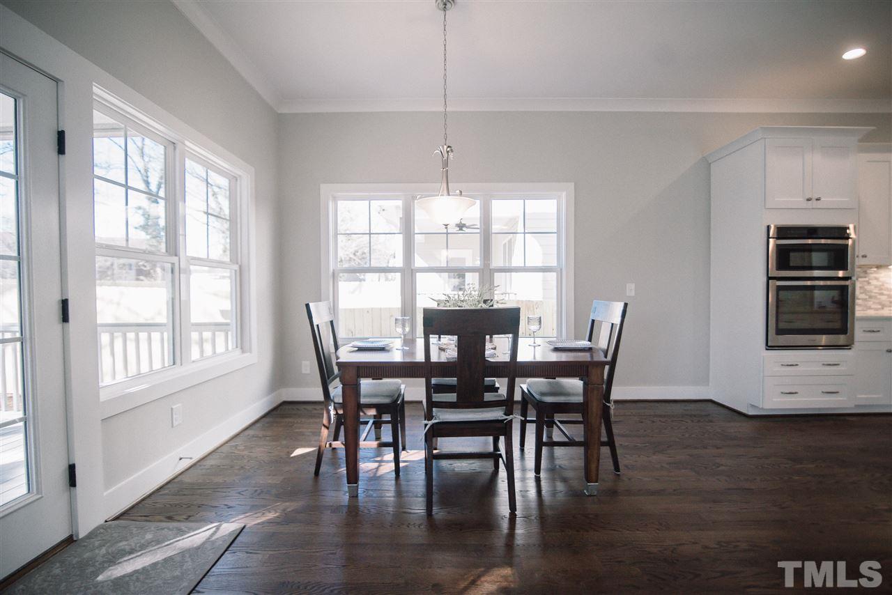 1508 East Lane Street Raleigh, NC 27610 - Photo 13 of 30 a view of a dining room with furniture window and wooden floor