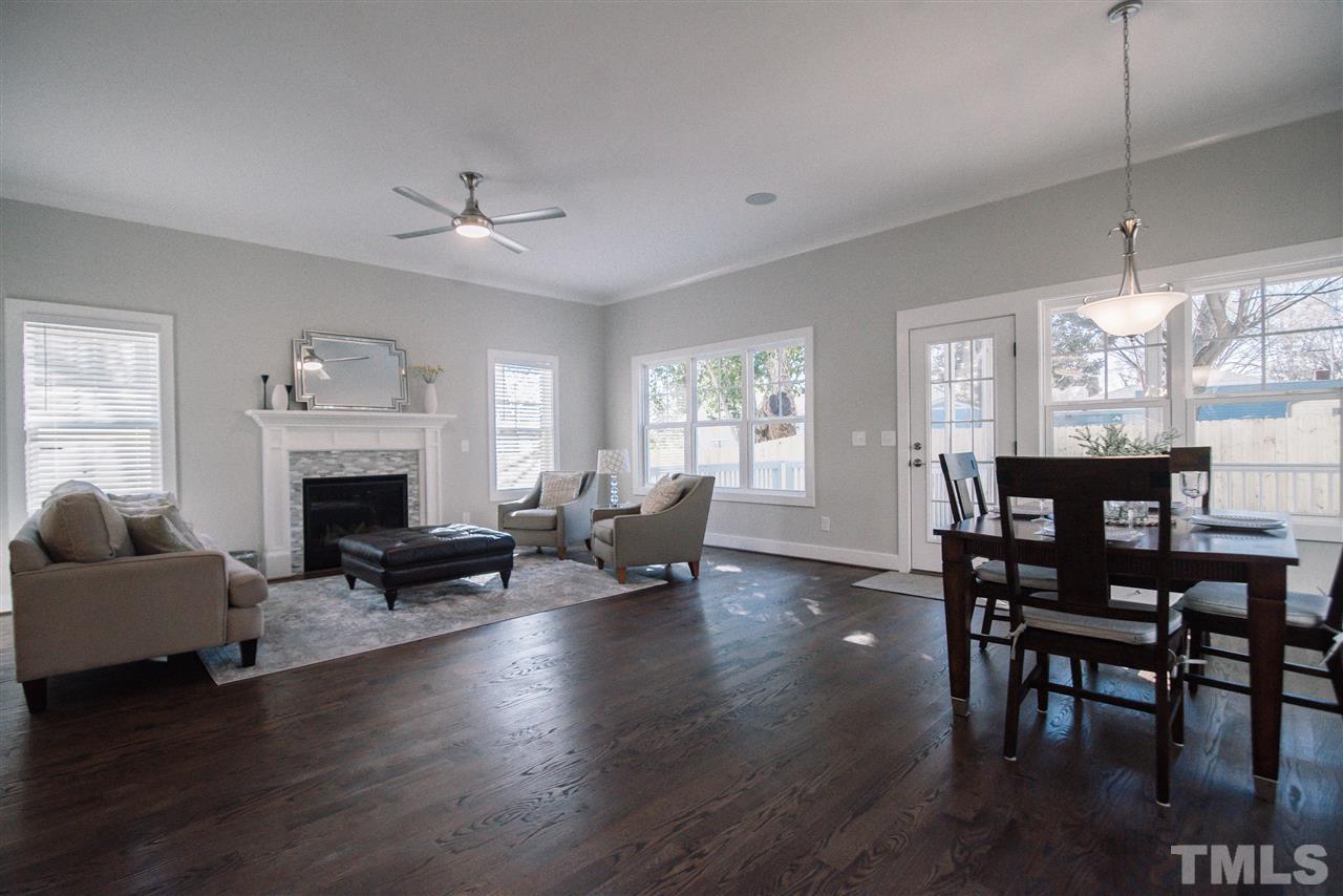 1508 East Lane Street Raleigh, NC 27610 - Photo 15 of 30 a living room with furniture dining table and a fireplace