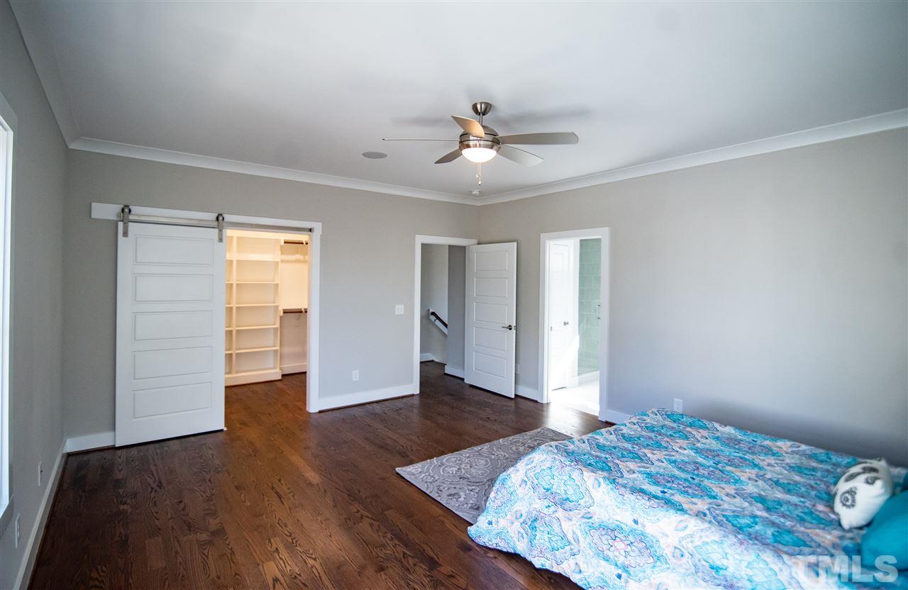 1508 East Lane Street Raleigh, NC 27610 - Photo 22 of 30 a bedroom with a bed and wooden floor