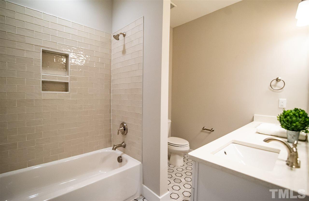 1508 East Lane Street Raleigh, NC 27610 - Photo 26 of 30 a bathroom with a tub sink and mirror