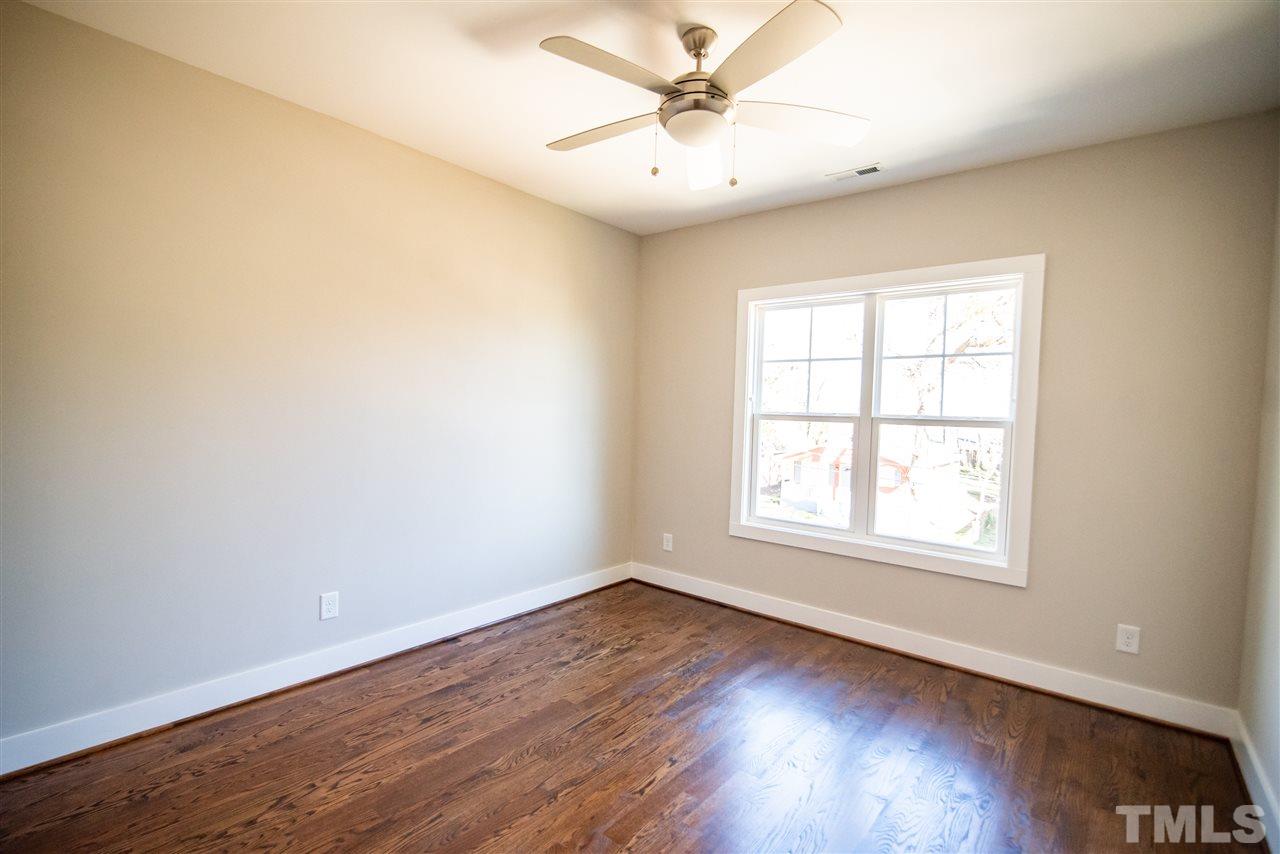 1508 East Lane Street Raleigh, NC 27610 - Photo 27 of 30 an empty room with wooden floor and windows