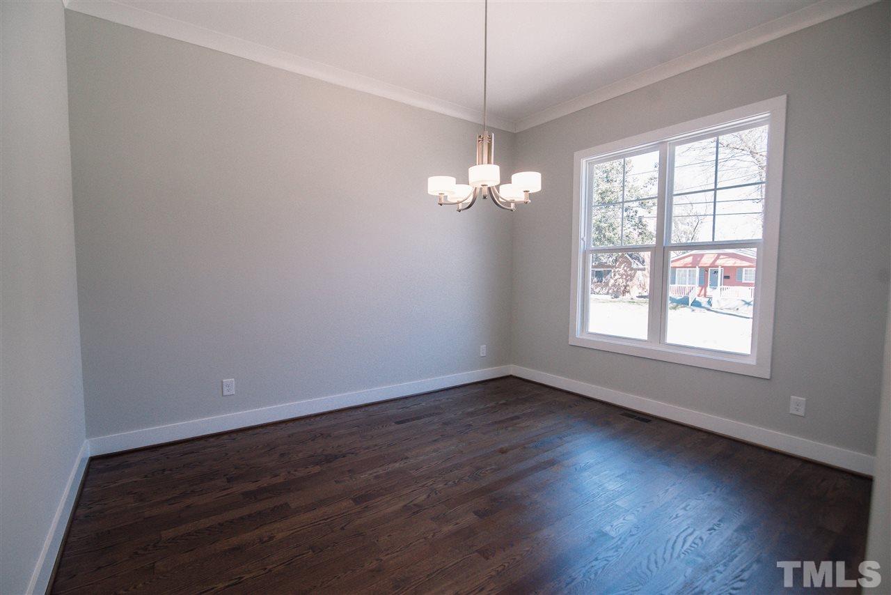 1508 East Lane Street Raleigh, NC 27610 - Photo 4 of 30 an empty room with wooden floor and windows