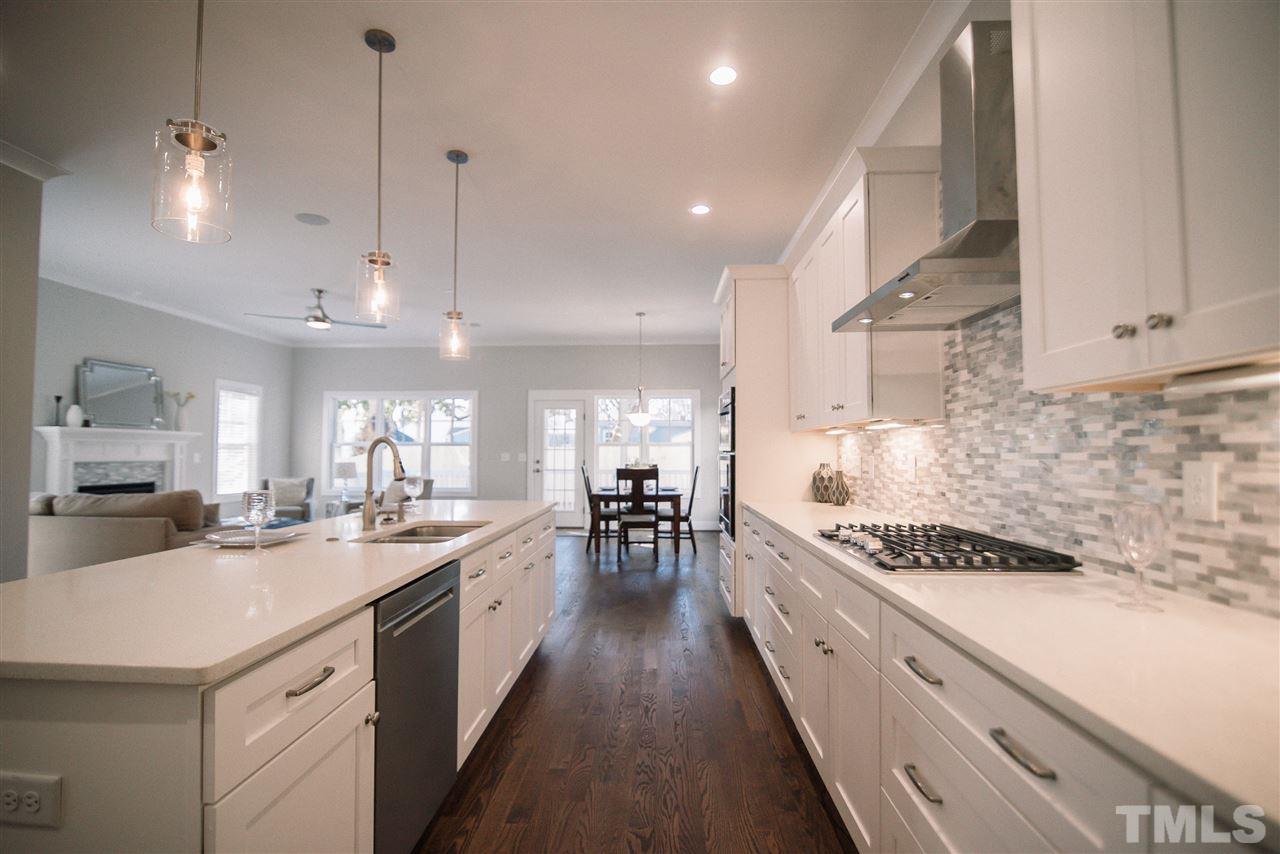 1508 East Lane Street Raleigh, NC 27610 - Photo 7 of 30 a large kitchen with kitchen island lots of counter space a sink appliances and cabinets