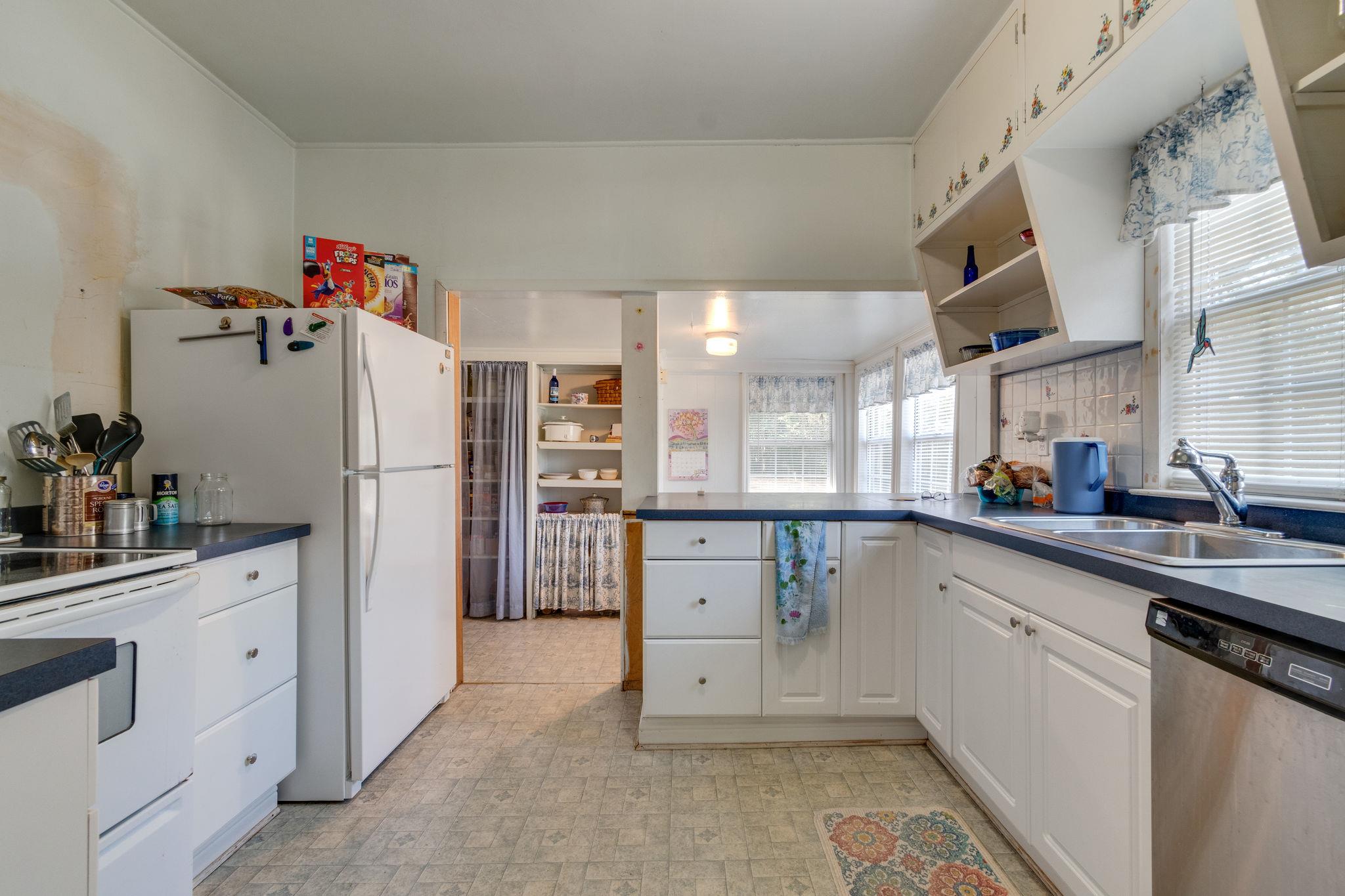 1452 Iron Bridge Road Columbia, TN 38401 - Photo 11 of 19 a kitchen with white cabinets and refrigerator