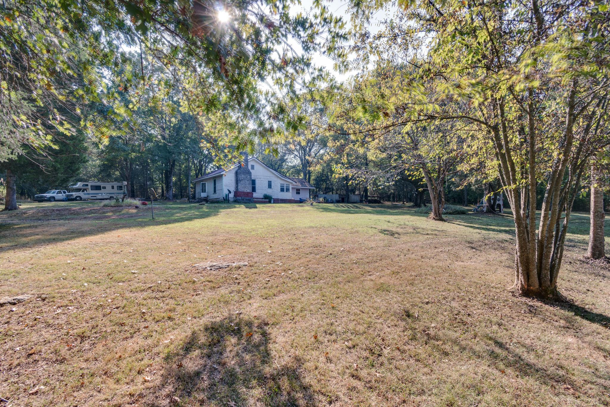 1452 Iron Bridge Road Columbia, TN 38401 - Photo 7 of 19 a view of a backyard with large trees