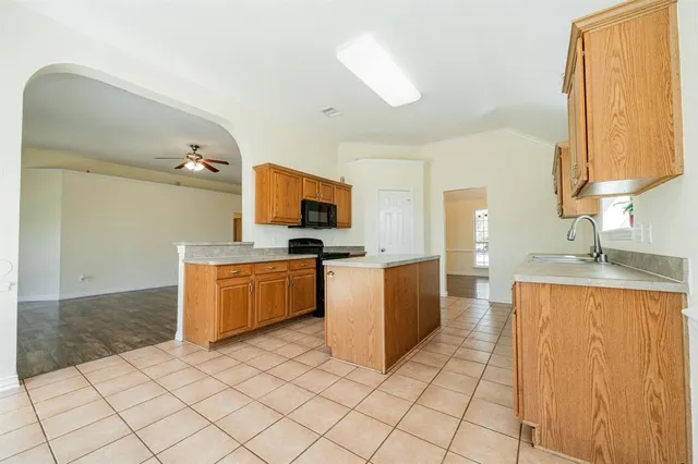 a kitchen with stainless steel appliances granite countertop a sink stove and cabinets