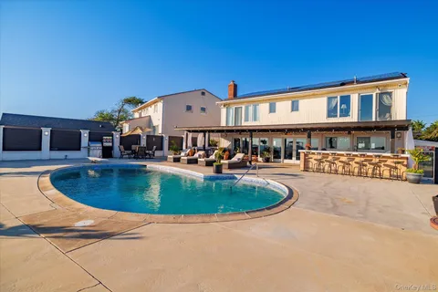 a view of a swimming pool with outdoor seating