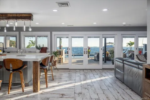 a kitchen with stainless steel appliances a table chairs and a wooden cabinets