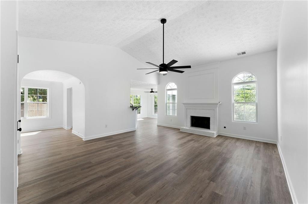 20 Mallet Pointe Street Northeast Cartersville, GA 30121 - Photo 6 of 37 a view of empty room with wooden floor fireplace and windows