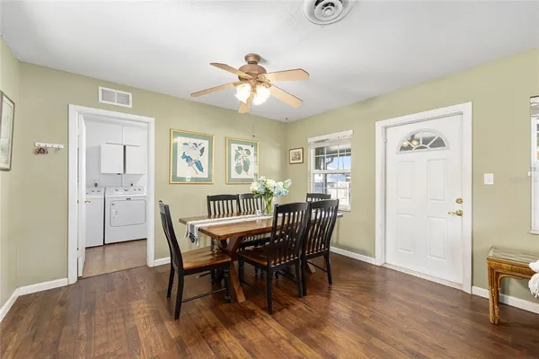 a view of a dining room with furniture and wooden floor