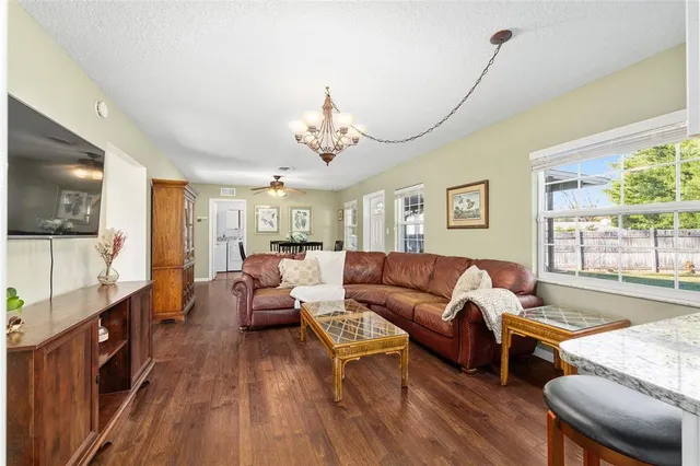 a living room with fireplace furniture and a flat screen tv