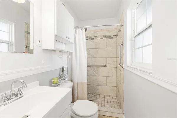 a bathroom with a sink toilet and shower