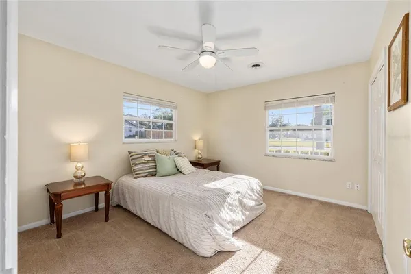 a bedroom with a bed and a painting on the wall