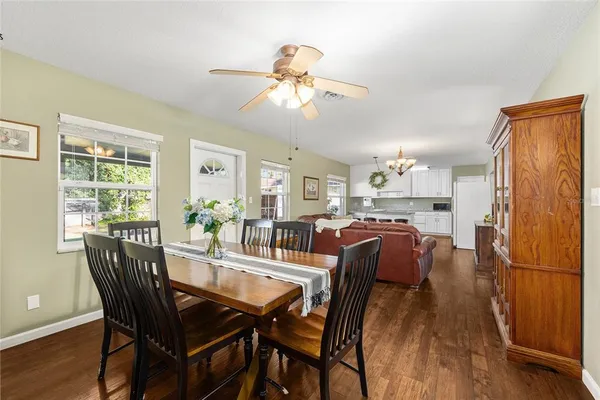 a view of a dining room with furniture window and wooden floor