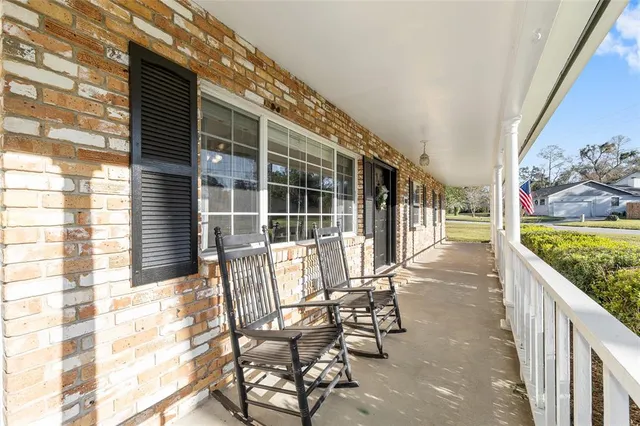 a view of a chair and tables in the balcony