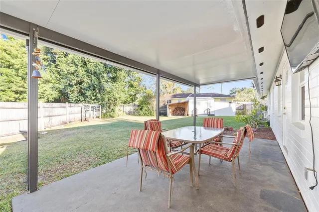 a view of a porch with chairs and backyard