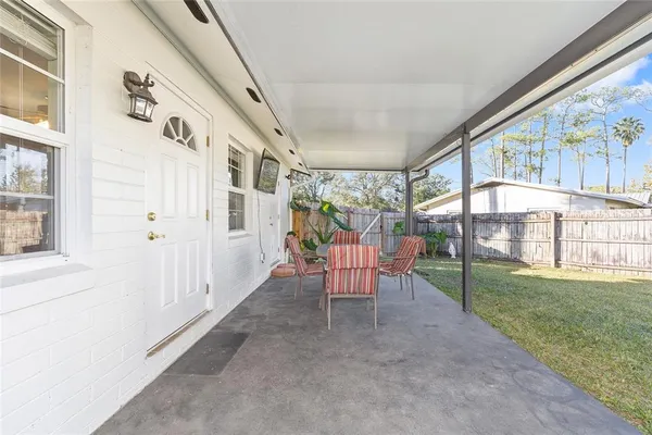 a view of a porch with chairs and backyard