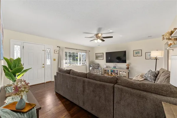 a living room with furniture potted plant and a window