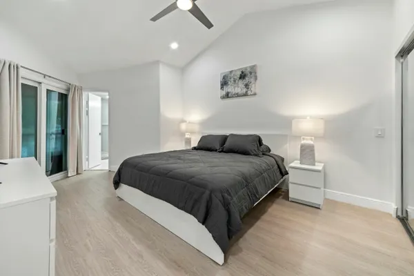 a bedroom with a bed and painting on the wall