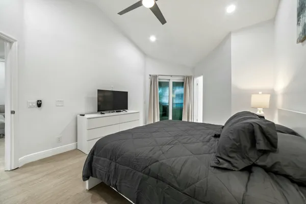 a bedroom with a bed and a flat screen tv