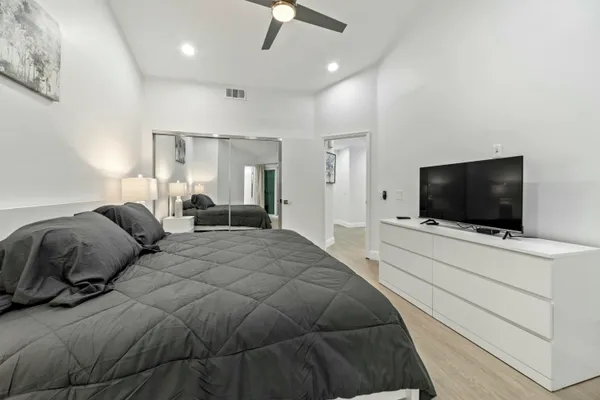 a bedroom with a bed and a flat screen tv